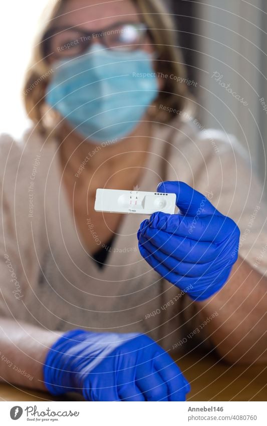 Senior woman holding a positive coronavirus self test at home, COVID-19 virus disease test,Coronavirus crisis,global pandemic outbreak,self test kit health