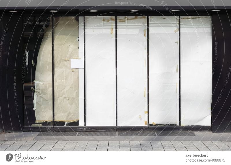 closed or empty shop or store storefront with blocked windows business vacancy closure economy crisis abandoned property lockdown shutdown bankruptcy shopfront