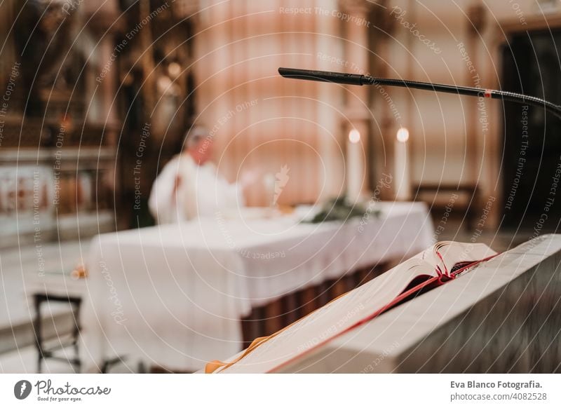 unrecognizable Priest during a wedding ceremony nuptial mass. Religion concept. Selective focus jesus ritual protestant modern divine cup eucharist goblet
