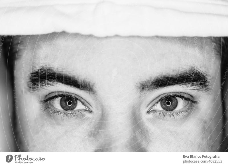 close up view of the eyes of a young man. black and white. led ring reflection in the eyes head people male dramatic person lifestyle closeup shot one lonely