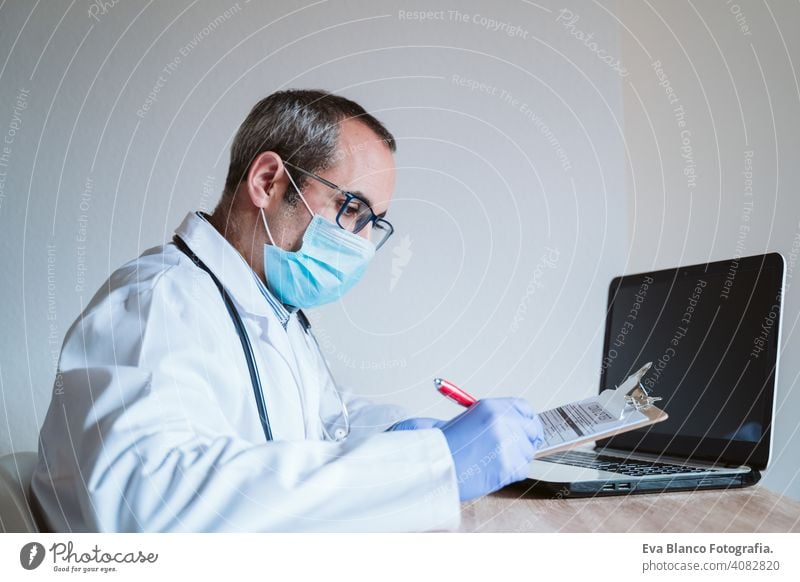 doctor man working on laptop. Corona virus test on table. Covid-19 concept corona virus covid-19 protective gloves protective mask technology analysis vaccine