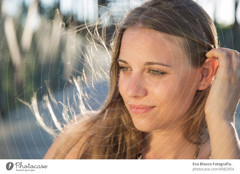 portrait of a beautiful woman at sunset Portrait young outdoors happy blonde blue eyes bridge summer sunny hair happiness lifestyle face fun white person sexy