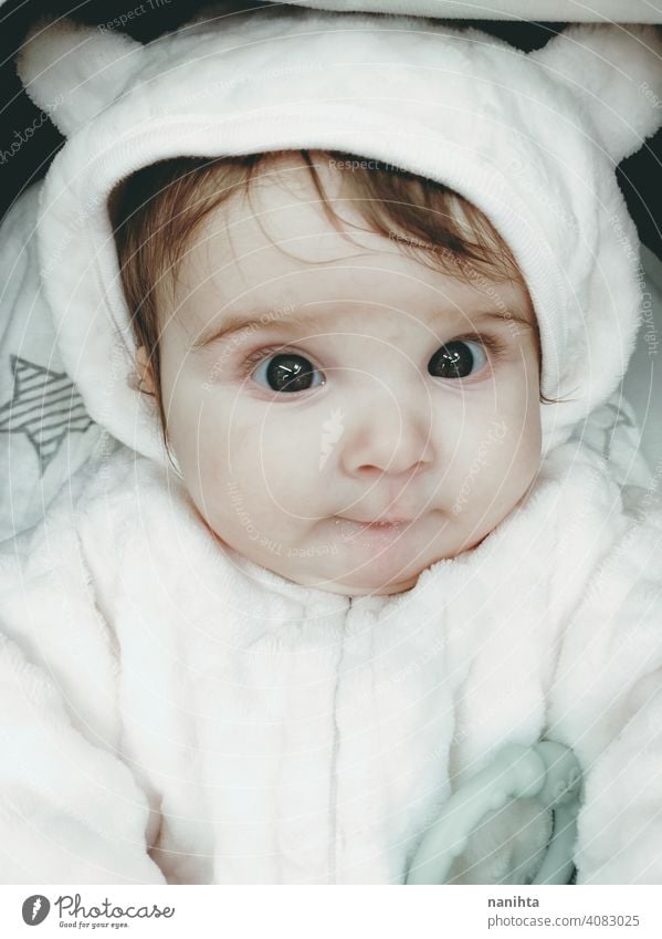Lovely portrait of a baby girl wearing winter clothes infancy cute little face eyes gray eyes newborn parenthood child cutie lovely adorable cozy pose