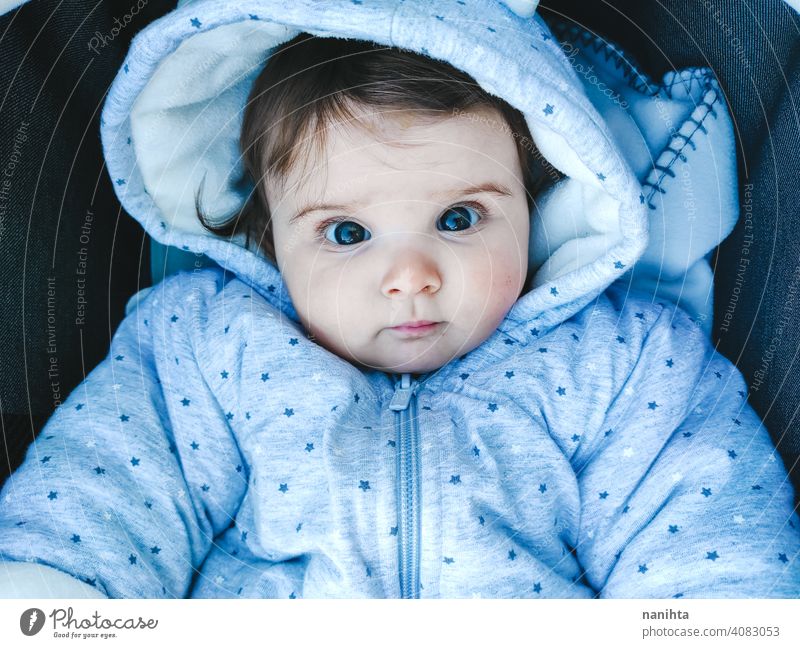 Lovely portrait of a 8 months baby girl cute lovely newborn life warm cozy hood hoodie childhood family kid parenting family time fun funny adorable innocence