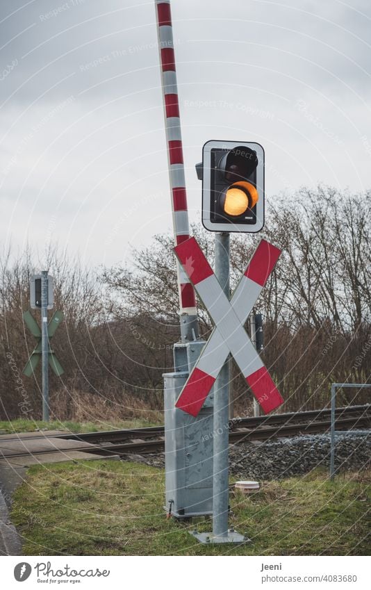 Even if the signal colour indicates yellow, you have to wait at the railway tracks railway barrier Control barrier Railroad crossing Track St. Andrew's Cross