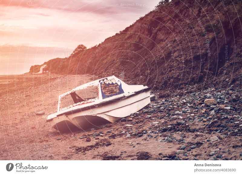 Old rusty boat on Thurstaston beach during low tide thurstaston beach Wirral Peninsula Merseyside England UK cloudy day holiday staycation outback summer