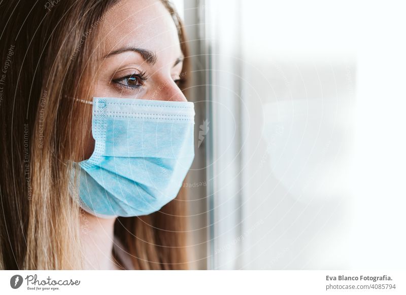 portrait by the window of doctor woman wearing protective mask and gloves indoors. Corona virus concept stop hand professional corona virus hospital working
