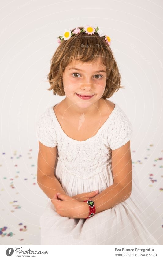 little girl portrait. indoors, confetti on the floor. white  background fun child cute lifestyle happiness cheerful kid beautiful hair face childhood caucasian