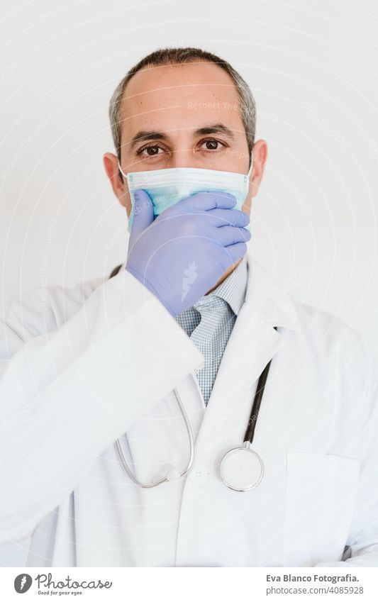 portrait of caucasian doctor using protective gloves and mask. Chinese Corona virus concept. 2019-nCoV stop hand man professional corona virus hospital working