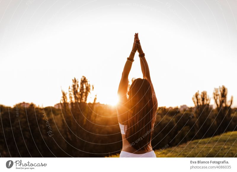 young beautiful asian woman doing yoga in a park at sunset. Yoga and healthy lifestyle concept summer happy enjoyment sport sportive relax relaxation field