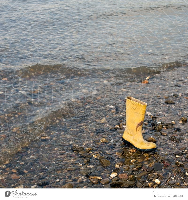 flotsam and jetsam Nature Earth Water Waves Coast River bank Beach Rhine Clothing Footwear Boots Rubber boots Yellow Mysterious Whimsical Stone Doomed