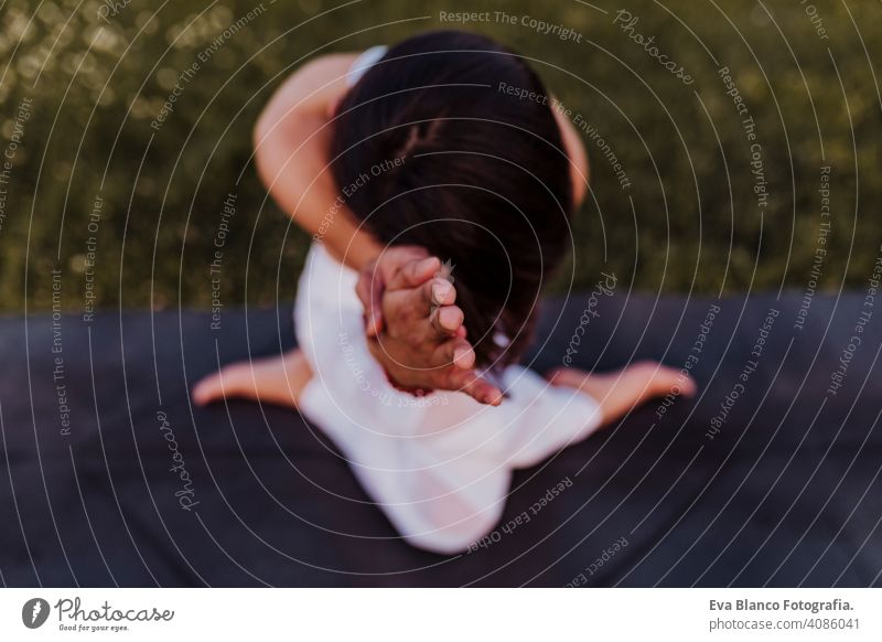 young beautiful asian woman doing yoga in a park at sunset. Yoga and healthy lifestyle concept. Top view. Selective focus summer happy enjoyment sport sportive