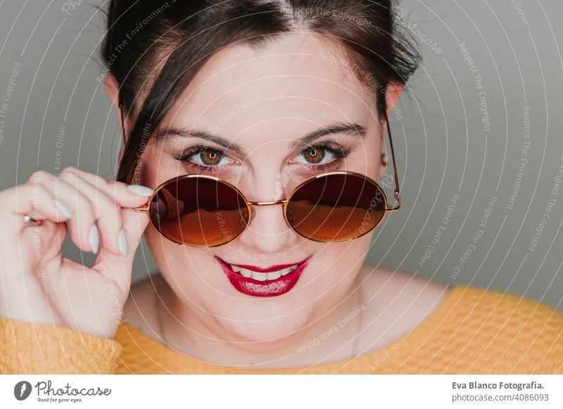 young woman close up portrait with sunglasses smiling. led ring reflection in the eyes. Real woman concept fashion glamor mouth caucasian makeup femininity