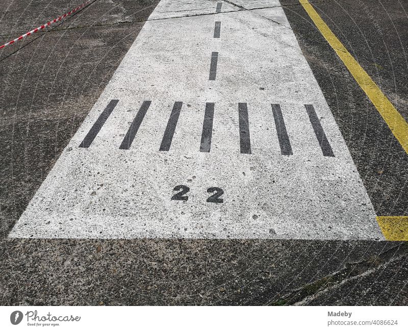 Runway painted on grey concrete for children in sunshine at airfield festival in Oerlinghausen near Bielefeld at Hermannnsweg in the Teutoburg Forest in East Westphalia-Lippe
