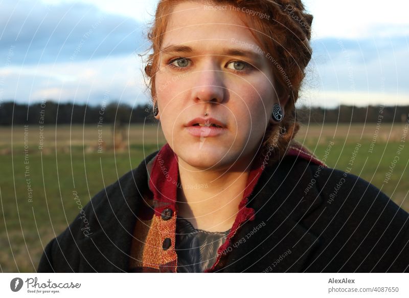 Young woman with dreadlocks in the evening sun on a pasture Woman Dreadlocks Identity naturally portrait Red-haired Esthetic Adults Youth (Young adults)