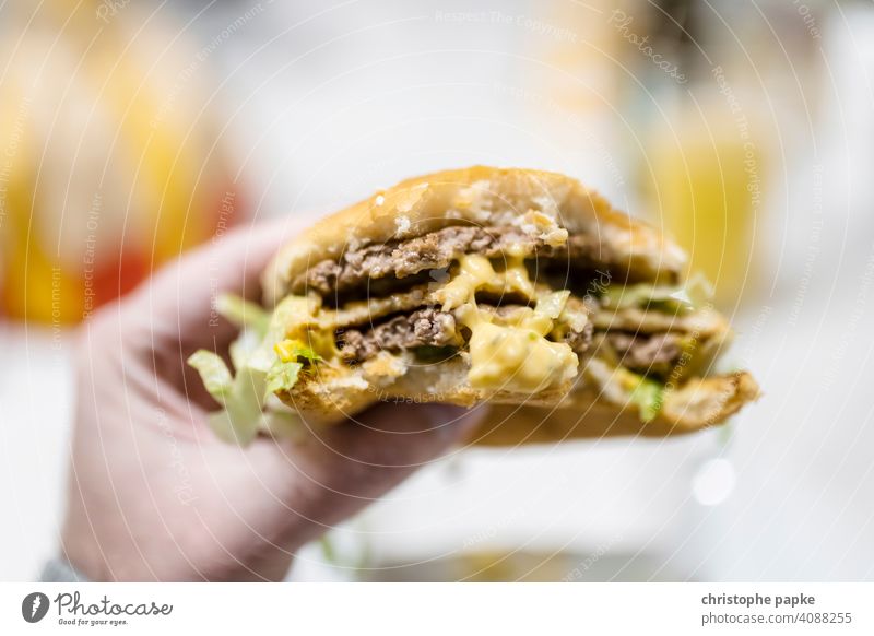 Hamburger in hand Fast food Nutrition I-perspective First person view pov Food Meat Lunch Unhealthy Cheeseburger Snack Close-up Meal Delicious Roll Beef Eating