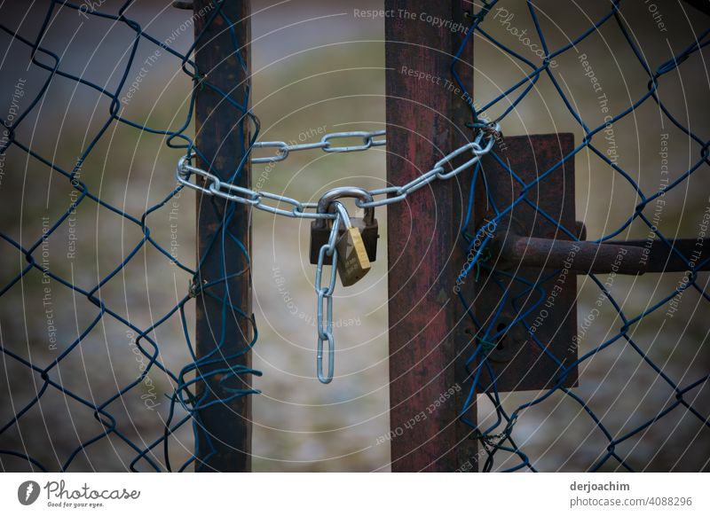 No way through.  Two old rusty lattice gates, are locked by a new padlock with chain, respectively secured. Safety Old Exterior shot Closed Colour photo Metal