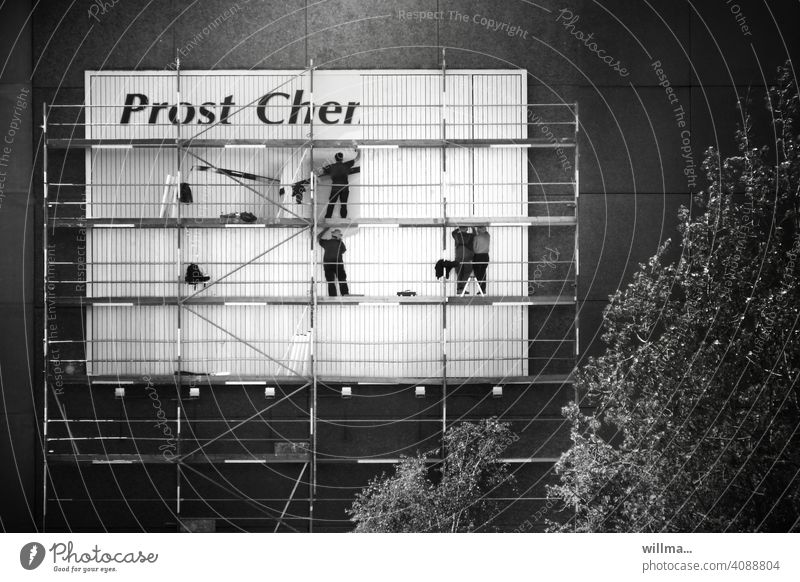 A poster is put up on a scaffold on a prefabricated building - Cheers Cher Poster Scaffolding Billboard sticker house wall Placard Advertising people men