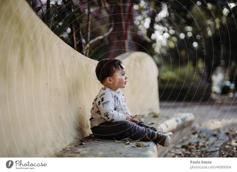 Boy sitting in the park Child 1 - 3 years Caucasian Park Cute Colour photo Infancy Toddler Human being Lifestyle Exterior shot Day Joy Children's game Authentic