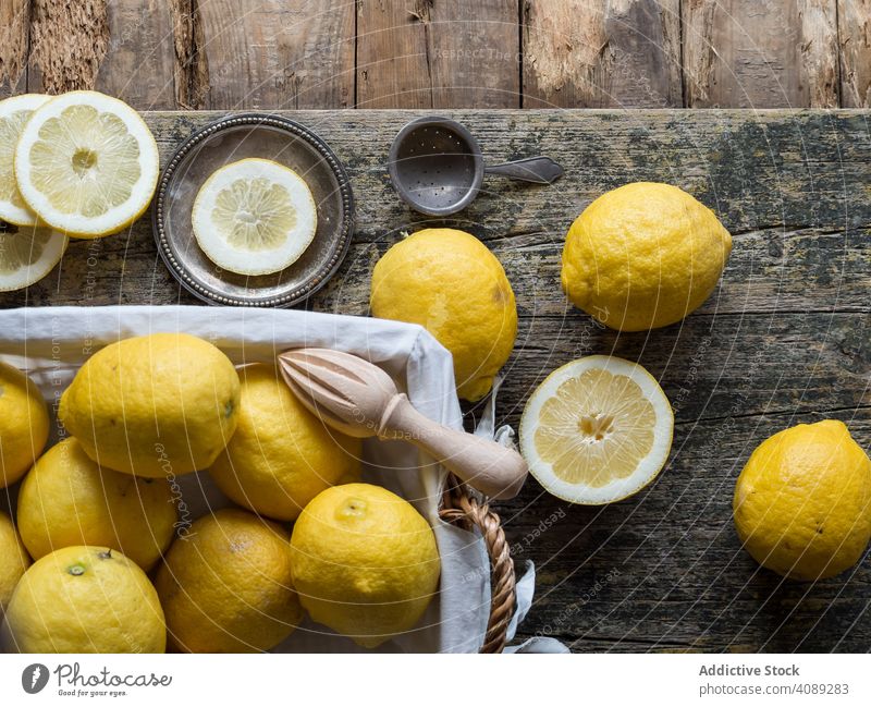 Lemons and reamer placed on wooden board lemon fruit citrus yellow food drink natural juice summer vitamin healthy fresh detox slice eating organic juicer