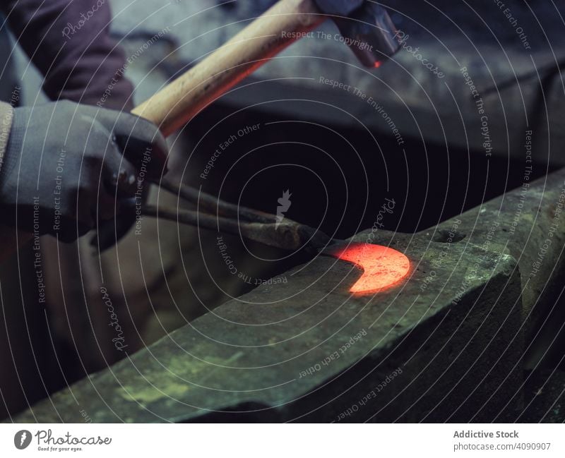 Blacksmith hands forging molten metal on anvil blacksmith hot hammer equipment tools traditional smithy workshop craft farrier old skill heavy metalwork