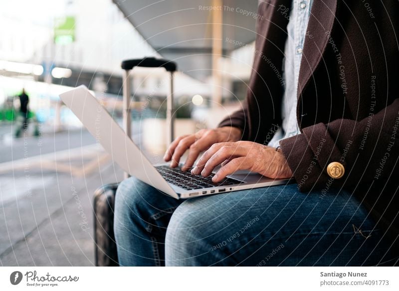 Close up of an unrecognizable business man using laptop. close up type 50s hands person lifestyle people middle aged handsome senior outdoors caucasian city