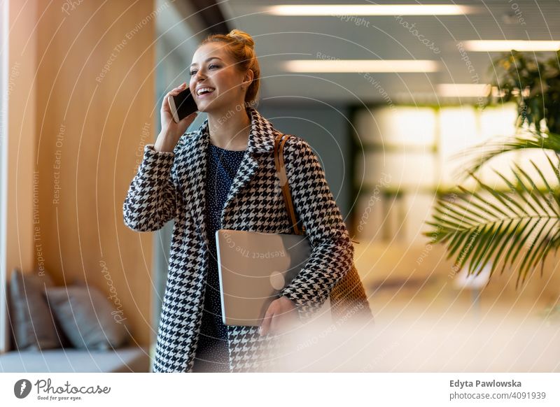 Young businesswoman using mobile phone in her office girl people Entrepreneur successful professional young adult female lifestyle indoors millennial attractive