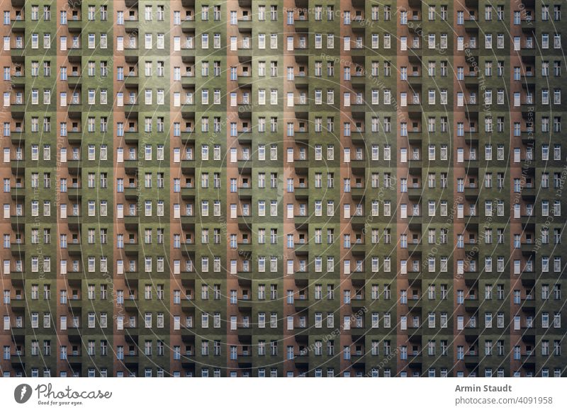 architectural pattern, dark facade with windows and balconies of a miserable berlin house seamless architecture repetition big huge many anonymous mega city