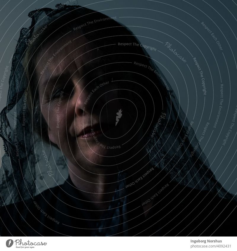Veiled woman partly in shadow with blue/gray background portrait Portrait photograph veiled Self portrait Woman contemplation Contemplative mournful mourning