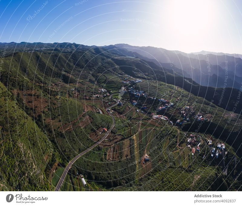 Curving road through desert landscape curving drone view empty aerial winding country green tenerife spain countryside sunny light travel trip weaving nature