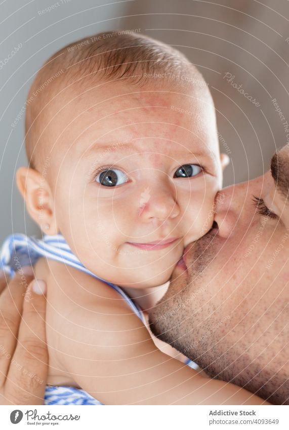Father kissing baby on cheek father love family child adult man happy childhood kid parent toddler smile closed eyes joy affection closeness bonding fondness