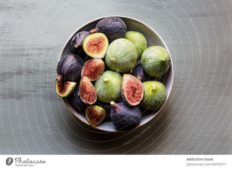 Plate of fresh ripe figs on kitchen table plate autumn colorful bowl harvest wooden berries bright fruit healthy organic sweet appetizer crop selective tasty