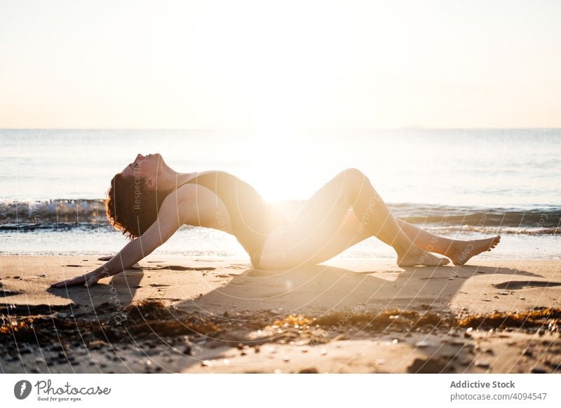 Slim woman relaxing on beach near sea sensual swimwear wave sky cloudless sunny slim female barefoot summer lifestyle ocean water vacation weekend travel trip