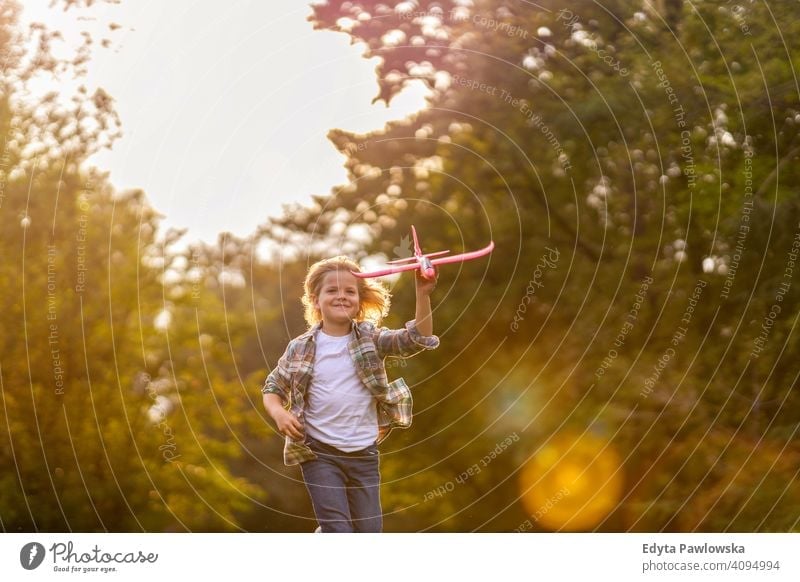 Little boy playing with toy plane in park people child little boy kids childhood outdoors casual cute beautiful portrait lifestyle elementary leisure preschool