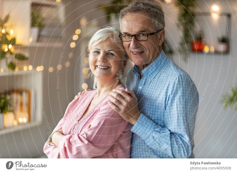 Happy senior couple at home people woman adult mature casual attractive female smiling happy Caucasian toothy enjoying two people love relationship portrait
