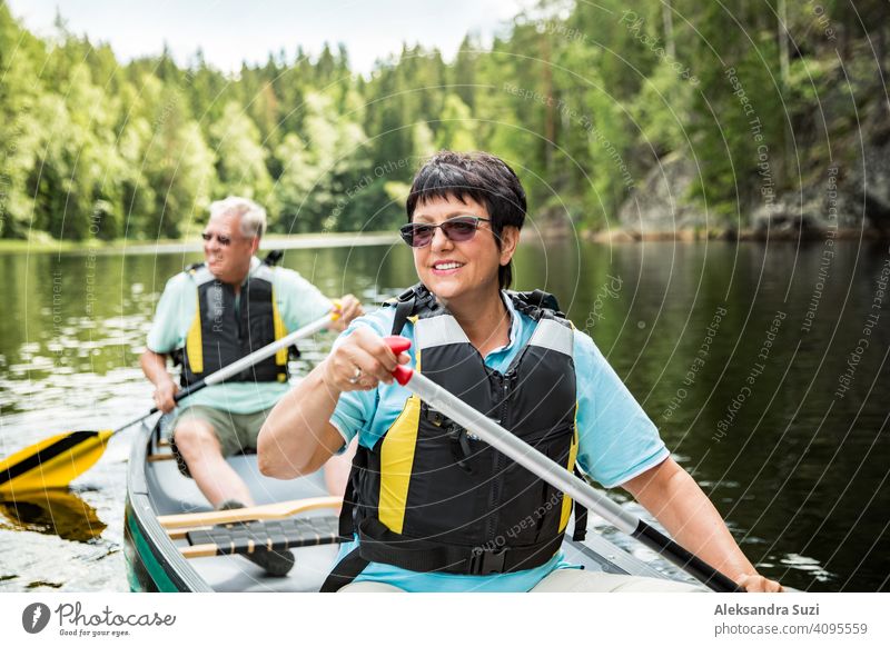 https://www.photocase.com/photos/4095559-happy-mature-couple-in-life-vests-canoeing-in-forest-lake-sunny-summer-day-tourists-traveling-in-finland-having-adventure-dot-photocase-stock-photo-large.jpeg