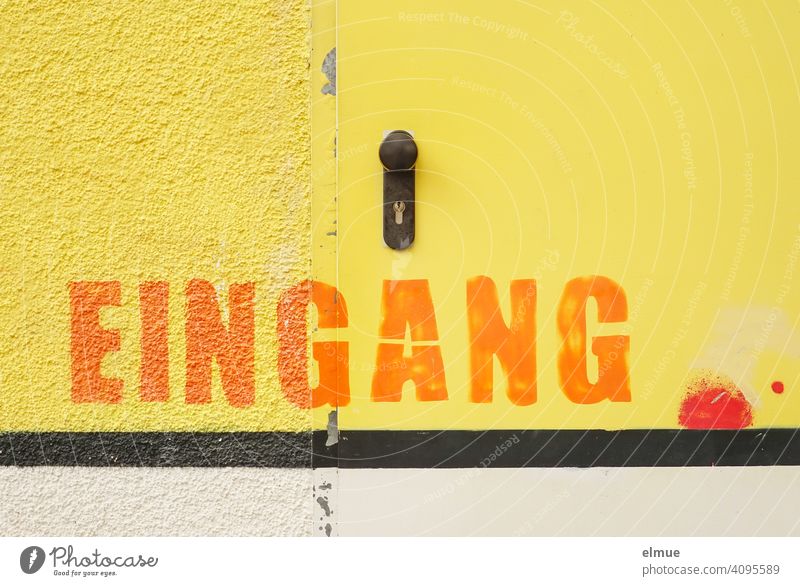 Wall and door are painted yellow and above a black stripe you can read in big orange letters EINGANG / Color Entrance Colour Stripe Wall (building) Yellow