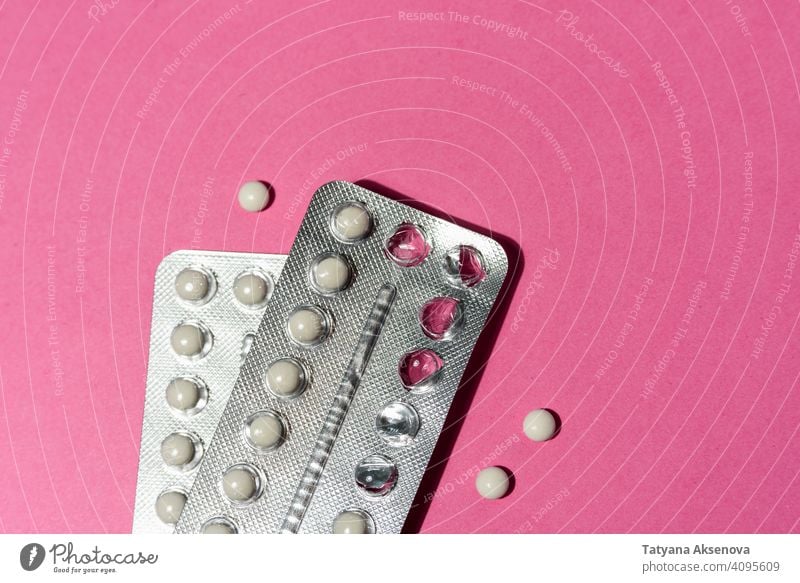 Birth control pills on pink birth contraceptive protection contraception woman medicine pregnancy ovulation sex prescription medical prevention gynecology