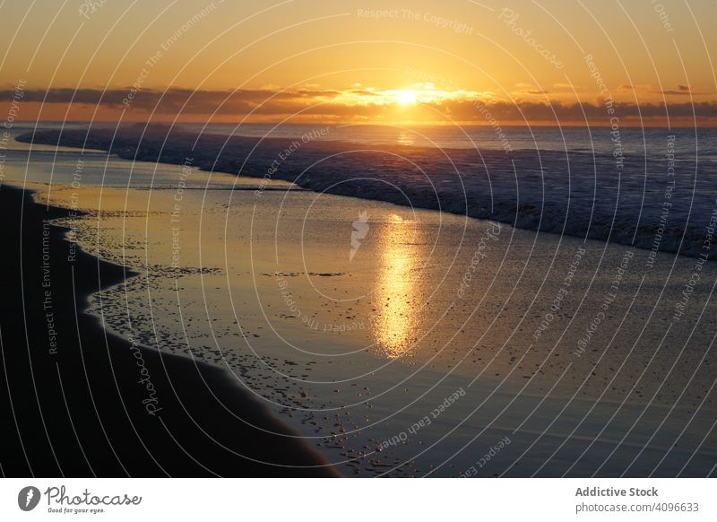 Colorful sunset over peaceful seashore colorful cloudy tranquil beach sandy wave spain gran canaria maspalomas horizon cloudscape ocean water vacation coast