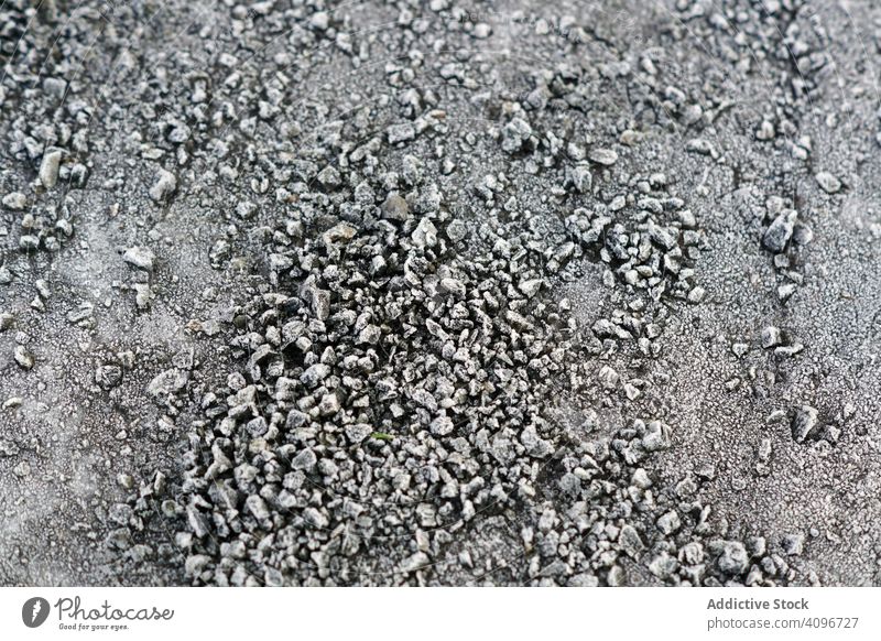 Pile of frosted pebble on ground pile texture small frozen rock grey icy snow natural abstract cobble dark boulder gravel material heap winter background
