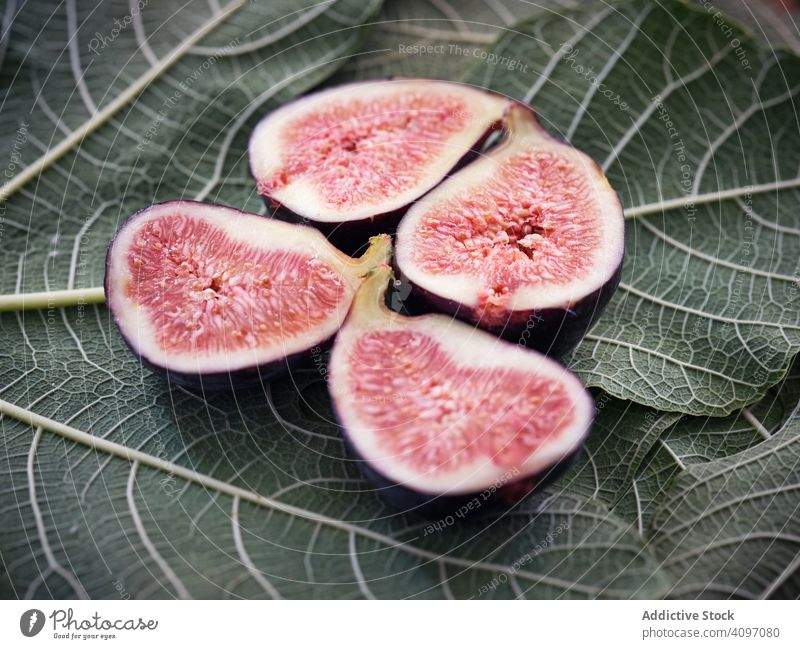 pieces of fig over table and green leaves leaf mature rustic fresh fruits rural tree food wooden traditional closeup spain home edible figs ripe bright
