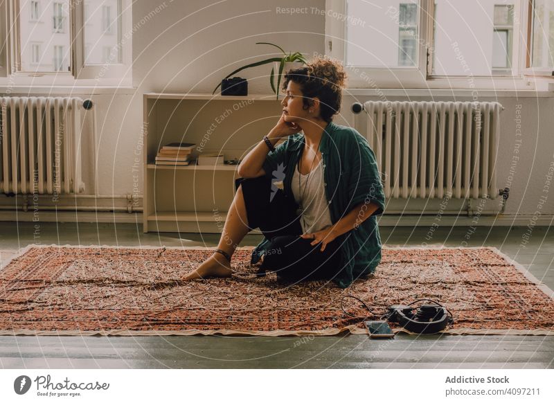 Happy and relaxed fitness girl, sitting on rubber mat doing yoga