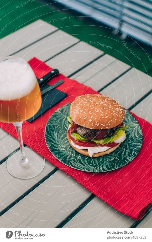 Cheeseburger with lettuce and tomato bun classic unhealthy table food meal cheeseburger onion beef delicious bbq grill snack hamburger american gourmet beer