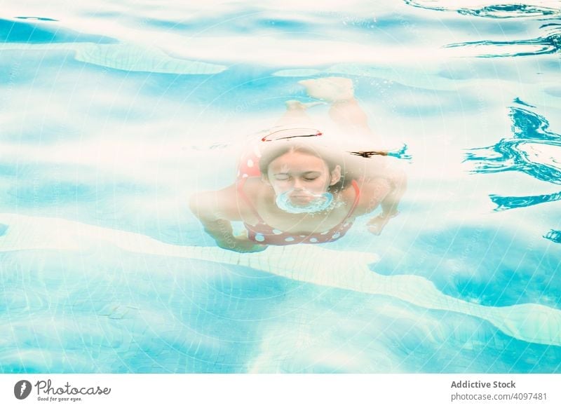 Happy teenager emerging from pool water swim bubble blow plunge resort fun play girl closed eyes emerge happy glad pleasure activity clean clear transparent joy