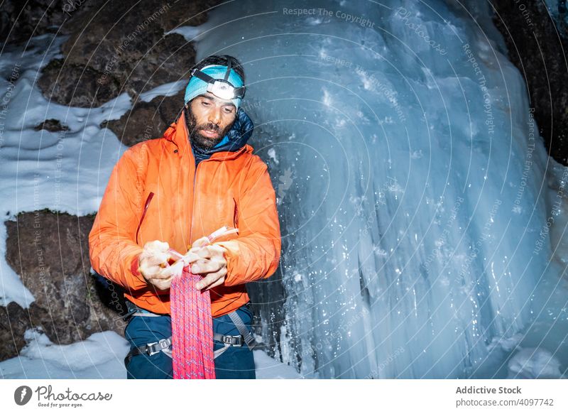 Tired climber carrying rope while standing by frozen glacier tired bearded equipment flashlight darkness toubkal africa morocco bundle iced snowy cliff mountain