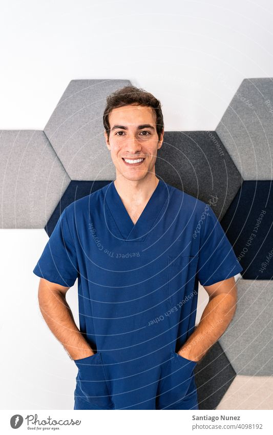 Male Dental Clinic Worker male man doctor uniform work uniform dental clinic looking at camera smiling indoors background portrait work clothes alone one person