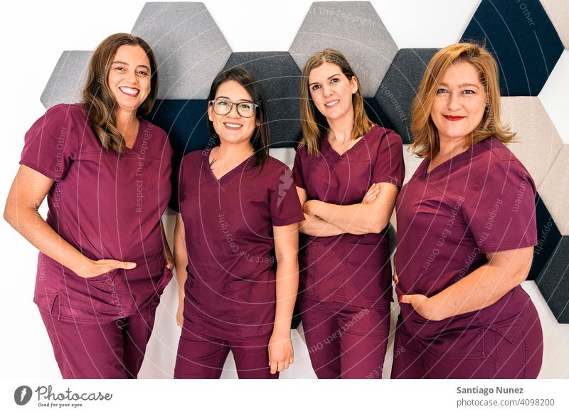 Female Dental Clinic Work Team women only women team work team dental clinic professionals together looking at camera at work workplace uniform work uniform