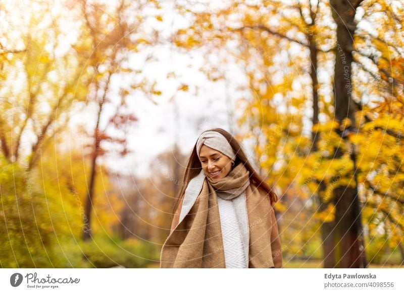 Portrait of a happy smiling young woman in winter clothes. Warm clothing,  outdoors, beautiful, attractive, red winter coat. by Marko Klarić. Photo  stock - StudioNow