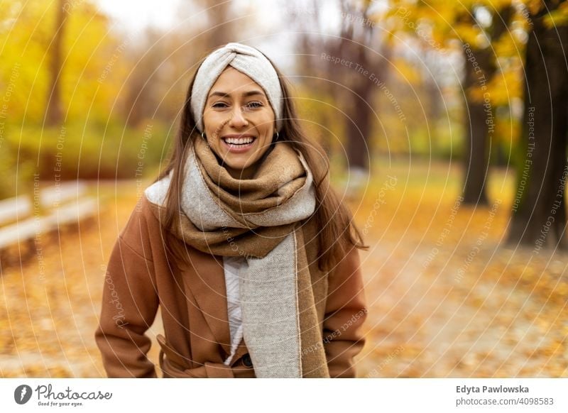 Portrait of a happy smiling young woman in winter clothes. Warm clothing,  outdoors, beautiful, attractive, red winter coat. by Marko Klarić. Photo  stock - StudioNow