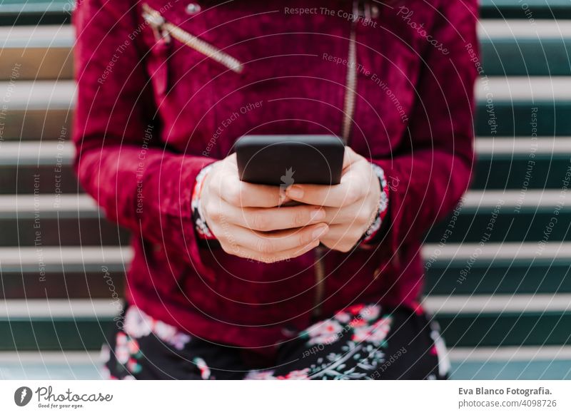 close up of beautiful caucasian woman in train station ready to travel using mobile phone. Travel and lifestyle concept technology smart phone internet device